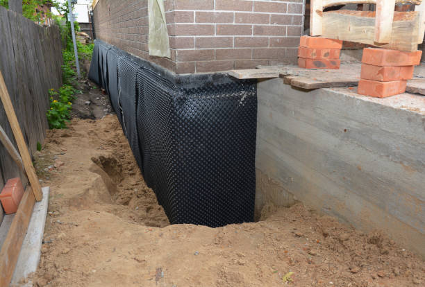 Happy homeowners after waterproofing job in Elwell